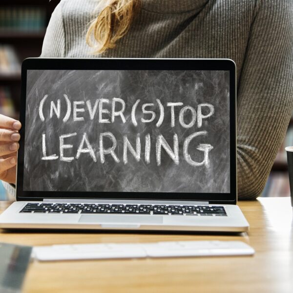 Image of laptop screen with the words Never Stop Learning on the screen.